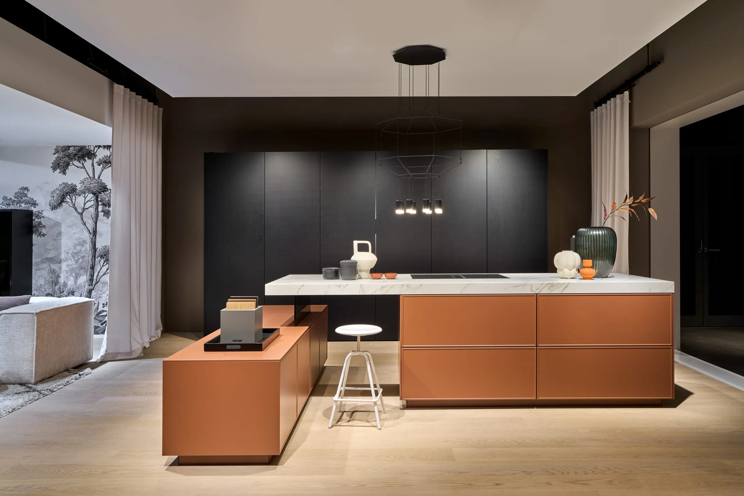 A dark Häcker kitchen with a terracotta-toned island